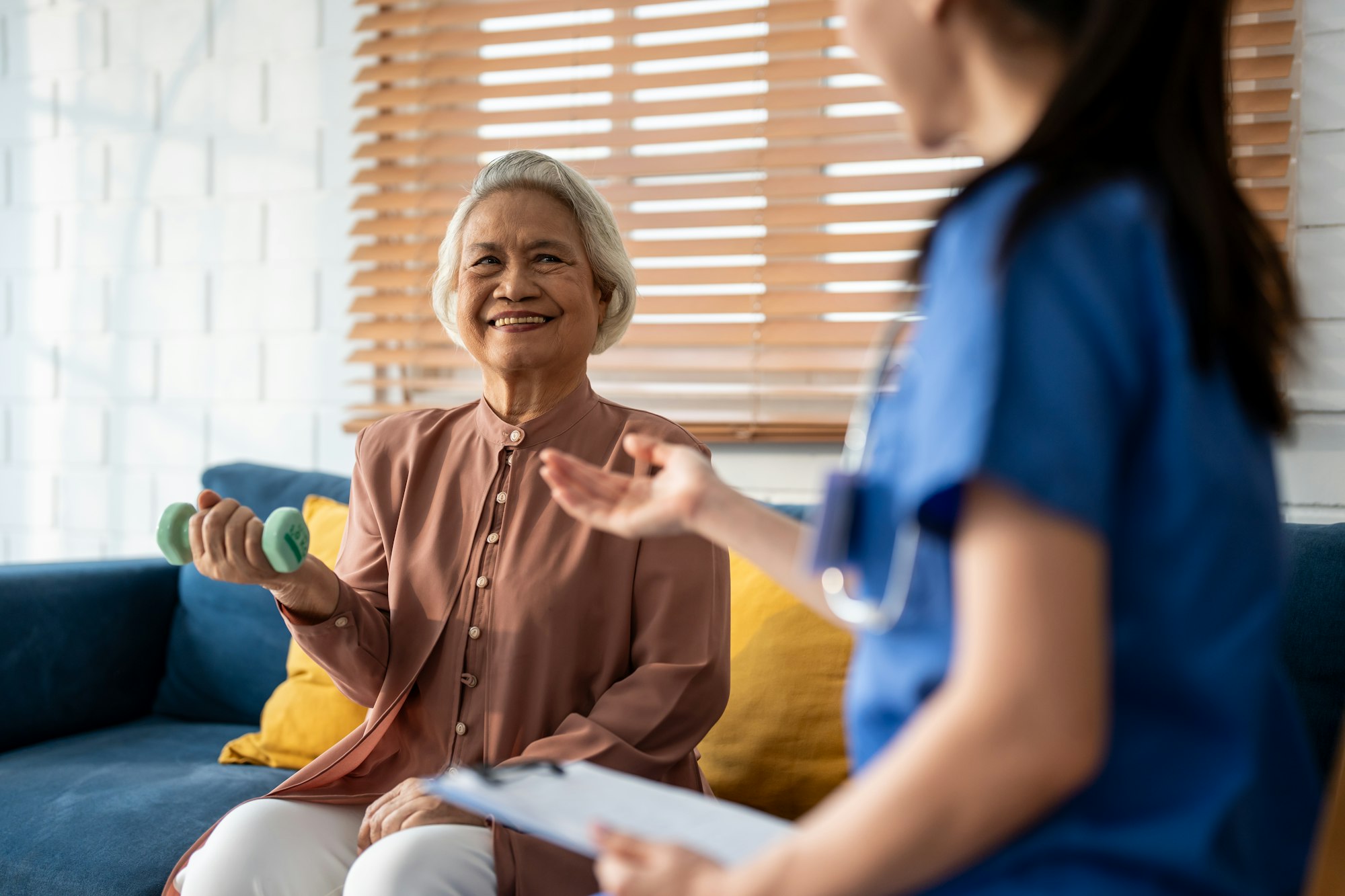 Asian senior elder woman doing physiotherapist with support from nurse.