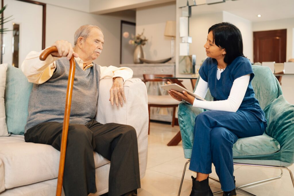 Home medical visit by a nurse to an elderly man