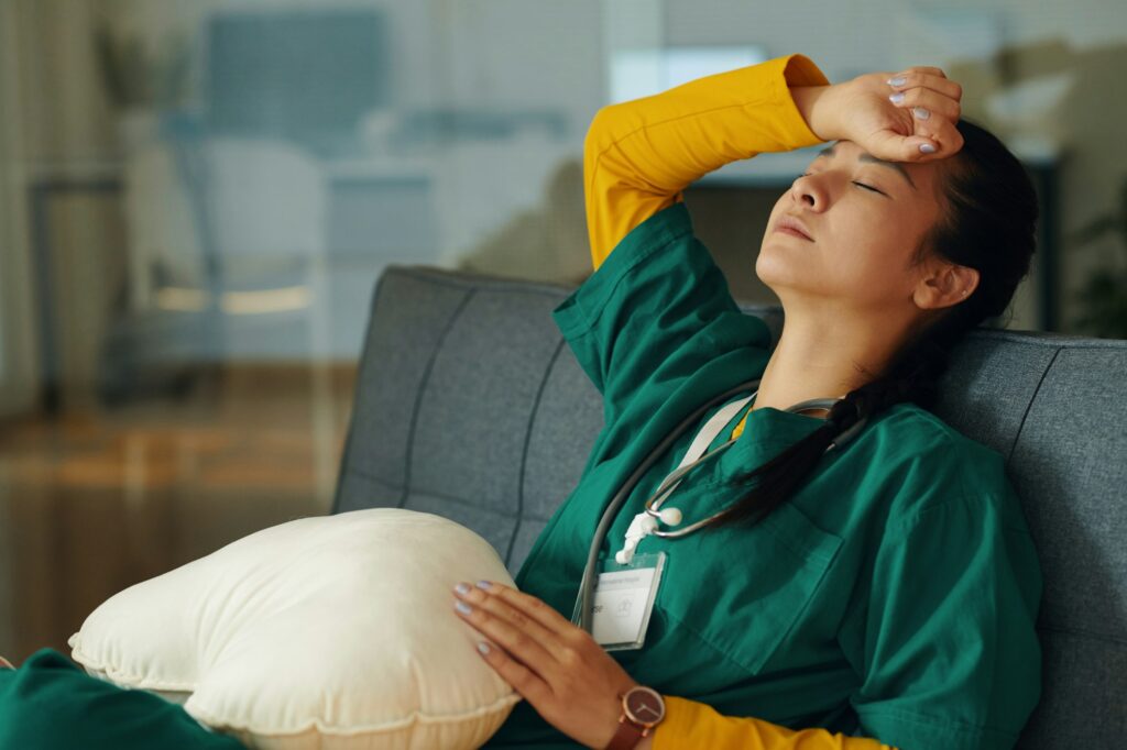 Tired Nurse Resting on Break in a Hospital Room